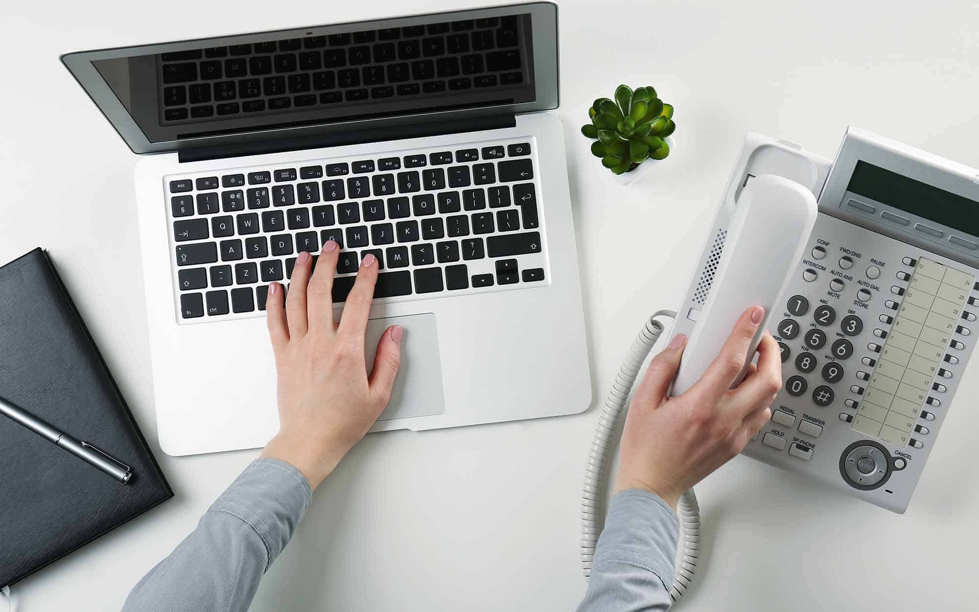 person using laptop and phone