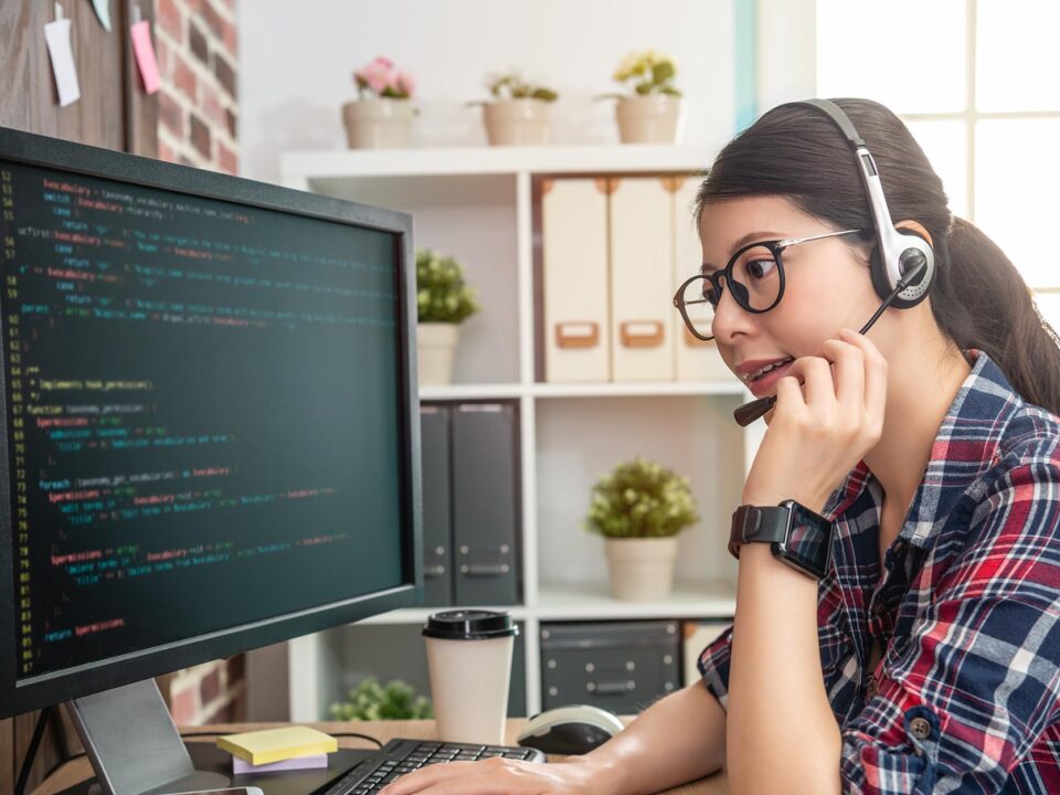 Image of a person on a support call while looking at code.