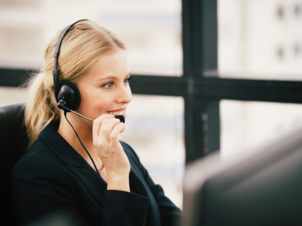 Side view of a woman working a customer service desk