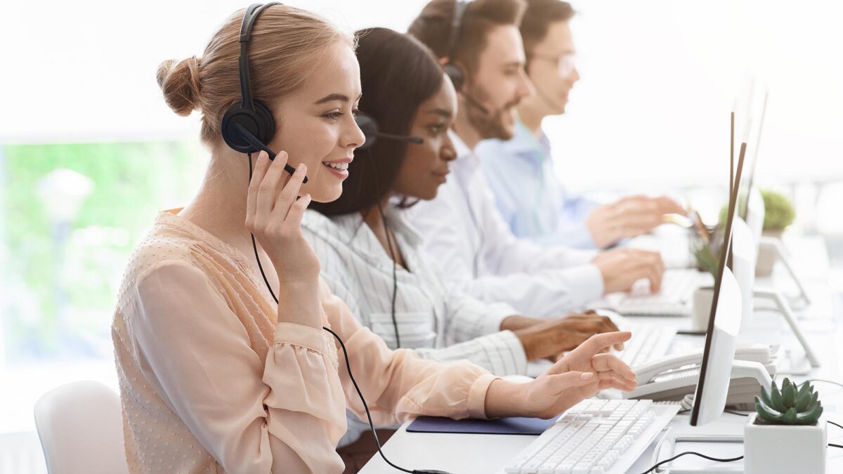 Tech support agents on calls at desks