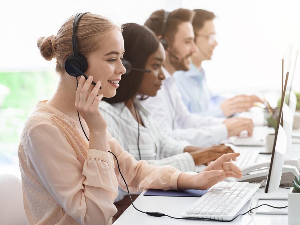 Tech support agents on calls at desks