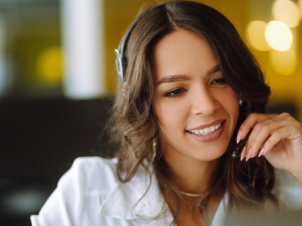 Young operator woman agent with headsets working in a call centre