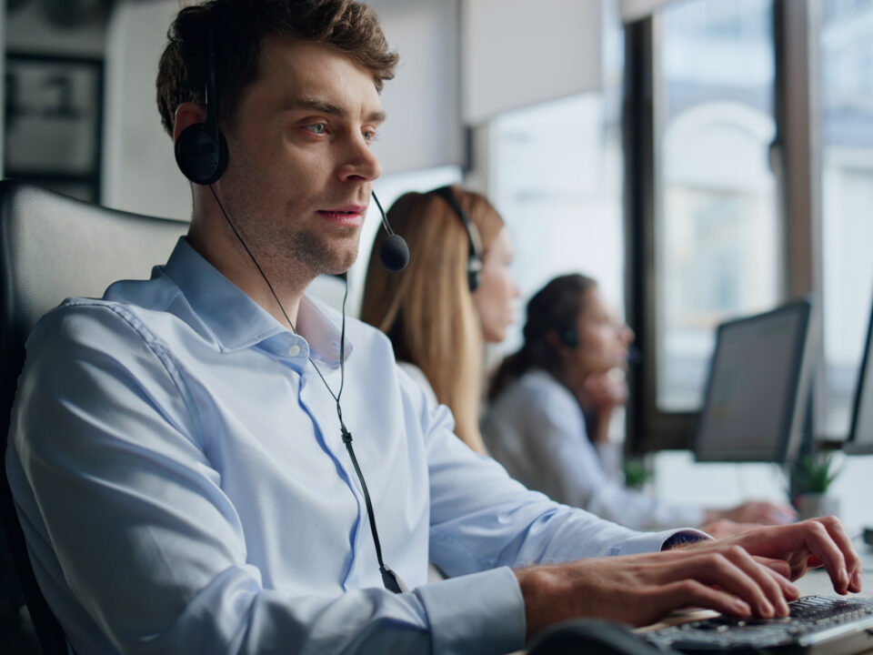 Hotline agent work computer in office. Professional support representative man