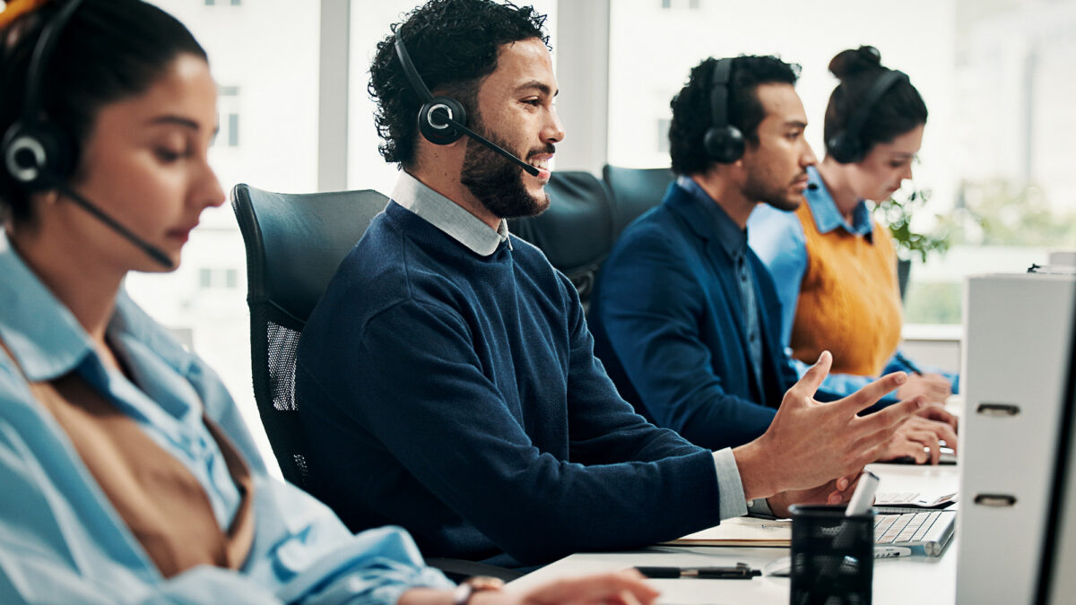 Call center, computer and man with advice, help desk an communication with coworking