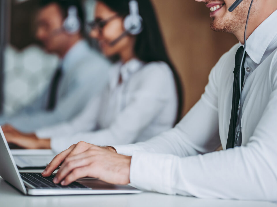 Call center workers at work smiling